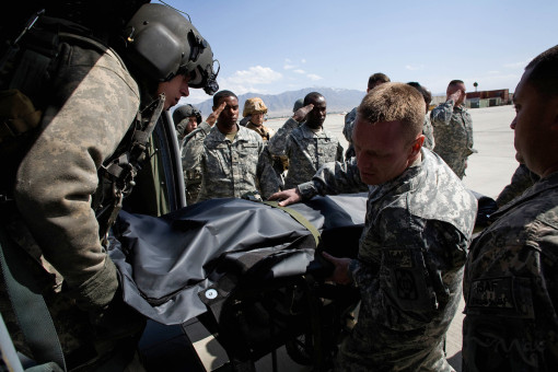 April 3, 2009- Bagram, Afghanistan: The body of Captain Petre Tiberius is unloaded from a helicopter by fellow Romanian soldiers and American medical personnel at Bagram Air Field in Afghanistan on April 3, 2009. The defense ministry in Bucharest, Romania announced Captain Petre Tiberius was killed in crossfire while leading a rapid intervention mission on Friday to support ISAF forces who had come under attack. Captain Tiberius was transported by helicopter to a forward surgical hospital but died in transit. Romania has lost 10 soldiers in Afghanistan.